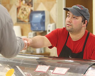 Frank Occhibove , Jimmy’s store manager, delivers a deli order to a customer. Occhibove’s parents own the Liberty store, which is expanding at its Belmont Avenue location.