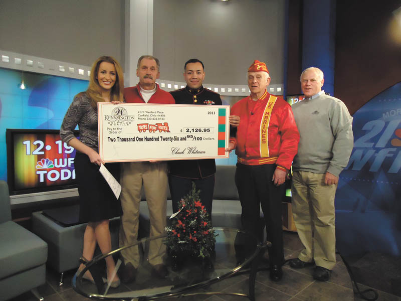 SPECIAL TO THE VINDICATOR
Canfield’s Kennsington Golf Club donated more than $2,000 to local Toys for Tots when it presented a check recently on the “WFMJ Today!” show with Lauren Lindvig, left. Next in line is Paul Otto, Kennsington golf pro; Marine Sgt. Modesto Montano, coordinator for the Mahoning-Trumbull Toys for Tots campaign; Harry Damph, a retired Marine; and Kennsington owner Chuck Whitman.