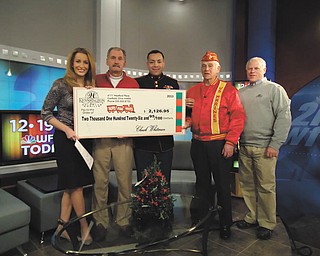 SPECIAL TO THE VINDICATOR
Canfield’s Kennsington Golf Club donated more than $2,000 to local Toys for Tots when it presented a check recently on the “WFMJ Today!” show with Lauren Lindvig, left. Next in line is Paul Otto, Kennsington golf pro; Marine Sgt. Modesto Montano, coordinator for the Mahoning-Trumbull Toys for Tots campaign; Harry Damph, a retired Marine; and Kennsington owner Chuck Whitman.
