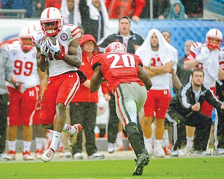 Nebraska wide receiver Quincy Enunwa catches a pass for a 99-yard touchdown reception in the second half of the Gator Bowl against Georgia on Wednesday in Jacksonville, Fla. The play — the longest in school history — gave the Cornhuskers the 24-19 win over the Bulldogs.
