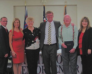 Special to The Vindicator: At Austintown trustees’ last meeting of the year, Joyce Pogany and Assistant Fire Chief Bill O’Hara were honored. Pogany was commended for leading the Wickliffe tree-lighting ceremony for the past 27 years, among other efforts, and O’Hara was recognized for playing Santa for many years. Beginning at far left are Trustees Jim Davis and Lisa Oles; Pogany; Trustee Rick Stauffer, whose year of service is up; O’Hara; and Laurie Wolfe, who was sworn in as fiscal officer while her family and friends watched.
