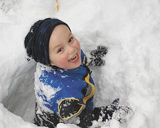 Ben Gaither, 2-year-old son of Becky and Bill Gaither of Austintown, frolicked in the pre-Thanksgiving Day snow tunnels made by his Uncle Mike Fox of Lowellville..