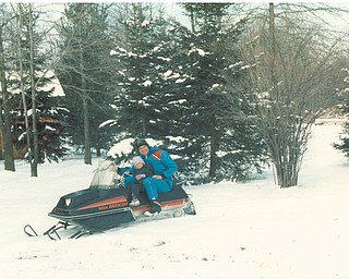 Lana Vanauker's brother Bill and her niece Angela relished riding a snowmobile in 1986 behind his home. Sent by Vanauker.