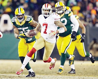 Forty-niners quarterback Colin Kaepernick (7) runs against the Packers defense during the first half of Sunday’s NFC wildcard playoff game in Green Bay, Wis.
