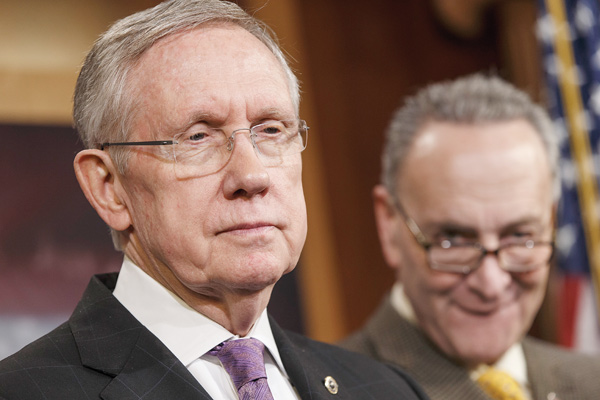 Senate Majority Leader Harry Reid of Nevada, left, accompanied by Sen. Charles Schumer, D-N.Y., listens during a news conference on Capitol Hill in Washington. Congress returns to work today with election-year politics certain to shape the agenda.