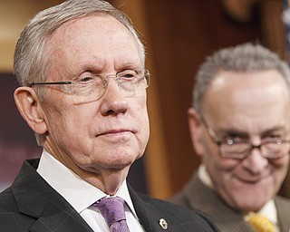 Senate Majority Leader Harry Reid of Nevada, left, accompanied by Sen. Charles Schumer, D-N.Y., listens during a news conference on Capitol Hill in Washington. Congress returns to work today with election-year politics certain to shape the agenda.
