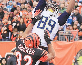 Chargers tight end Ladarius Green (89) catches a 4-yard touchdown pass against Bengals safety Chris Crocker (32) in the second half of Sunday’s AFC wild-card playoff game in Cincinnati.