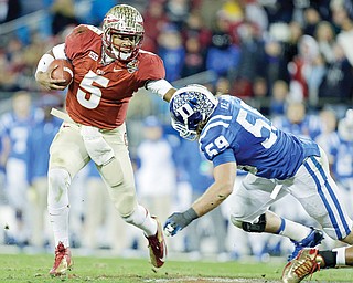 Florida State’s Jameis Winston (5) scrambles as Duke’s Kelby Brown (59) defends in the first half of the Atlantic Coast Conference Championship in Charlotte, N.C.