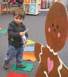 Ashton Williams, 2, of Poland ponders his next move while playing Candy Land recently at the library in Liberty.