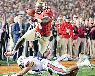 Florida State’s Chad Abram leaps over Auburn’s Ryan Smith for a touchdown during the second half of the BCS National Championship game Monday in Pasadena, Calif.