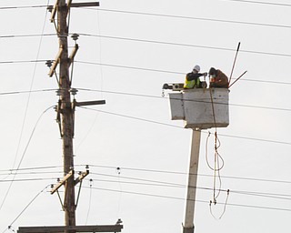 Ohio Edison battled low temps hovering around zero. strong winds and birds as they replaced a transmission line near 711 and MLK Boulevard near Brier Hill. late Tuesday afternoon.