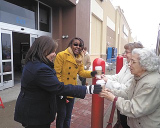 SPECIAL TO THE VINDICATOR
The Brookdale Elves, seniors from Clare Bridge Austintown and Sterling House Youngstown, provided hot chocolate to Salvation Army bell-ringers from Dec. 4 at various times and locations through the holiday season. Jo for the Road provided the hot chocolate at a discount. Above, from left, are Taylor and Raven, Salvation Army volunteers working in front of Walmart in Austintown, who were served hot chocolate by elves Dorothy Thomas and Marguerite Cronin. Below, Salvation Army volunteer Heather, left, is receiving her hot chocolate from Thomas in front of Giant Eagle, also in Austintown.