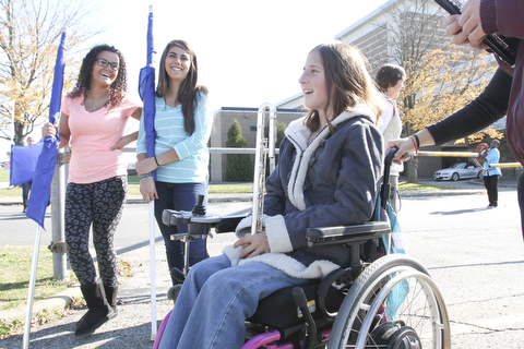 William D Lewis The Vindicator  Kaitlin Windt at Boardman HS 10-30-13. She is in a wheelchair and performs with the Boardman Marching band. She is shown with flagline members Alexis Perez, left, and Jessica Barone.