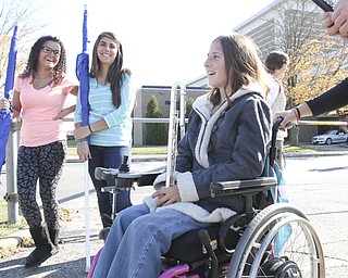 William D Lewis The Vindicator Kaitlin Windt at Boardman HS 10-30-13. She is in a wheelchair and performs with the Boardman Marching band. She is shown with flagline members Alexis Perez, left, and Jessica Barone.