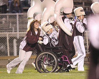 William D LEwis The Vindicator Boardman band member Kaitlin Windt, in wheelchair, gets help from Rachael Ruggieri during 11012013 halftime show.