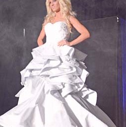 Krystal Naples walks the runway modeling a wedding gown from Evaline’s Bridal shop of Warren during the bridal
show at the Covelli Centre in Youngstown on Sunday afternoon.