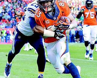 Broncos WR Wes Welker crosses the goal line after a nine-yard touchdown catch against Chargers DB Darrell Stuckey in the second quarter of Sunday’s AFC division playoff in Denver. The Broncos held off the Chargers to win 24-17 and advance to the AFC championship against the New England Patriots.