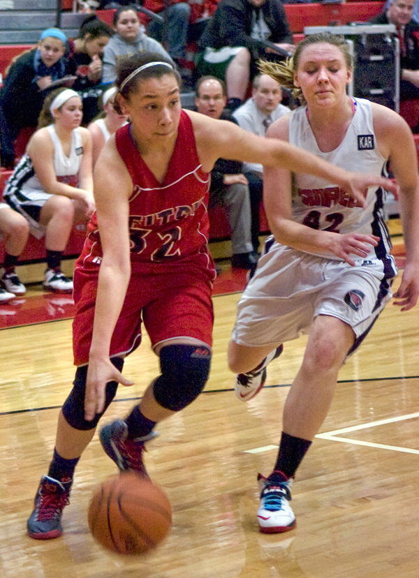 Austintown Fitch guard Allexis Sallee drives toward the basket Monday night against Canfield defender Erin Risner at Canfield High School.