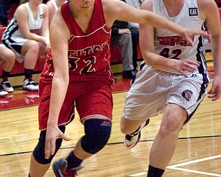 Austintown Fitch guard Allexis Sallee drives toward the basket Monday night against Canfield defender Erin Risner at Canfield High School.
