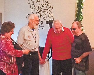 Members of the club presented a check to a sight-impaired member. They raised more than $3,000 last year to buy him specialized equipment, and the check was for the balance in the fund after the purchase. From left to right are Stein, Haren, Ted Filmer and Mike Austin.