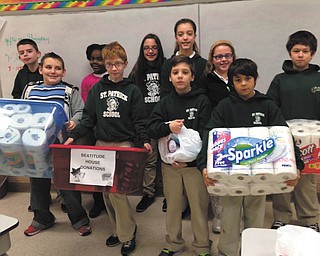 SPECIAL TO THE VINDICATOR
Students and staff members at Hubbard’s St. Patrick School, a Lumen Christi School, collected household and personal care items for donation to Beatitude House. Students delivered the items and stocked the shelves to enable Beatitude House to continue to help those in need. In the front, from left to right, are Michael Hamad, Simon Yesh, J.J. Scarmuzzi and Jordan Serrano. In back are Cooper Muccio, Treshaunti Brown, Daniella Hosack, Giavanna Hosack, Katie Cigolle and Ryan Baytosh.