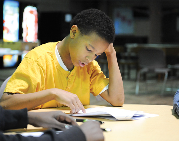 Clayton Felder, 15, of Youngstown reads aloud about various financial topics to a group of high-school age
students during a financial workshop Monday at the Boys & Girls Club of Youngstown.