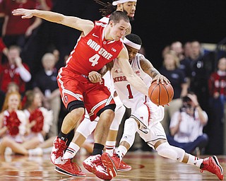 Ohio State guard Aaron Craft (4) steals the ball from Nebraska’s Deverell Biggs (1) in the first half of a game in Lincoln, Neb., on Monday.