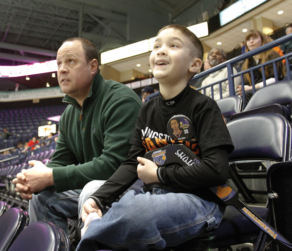 Chris Litton of Youngstown and his son Jack, 6, were among the few hardy souls who braved the brutal weather to watch the Youngstown Phantoms take on the Indiana Ice at the Covelli Centre in downtown Youngstown at the local hockey team’s annual School Day Game. The weather caused many schools to cancel classes, and few students were able to make it to the center for the 10:15 a.m. contest Wednesday. The Phantoms have set another School Day Game for March 21, when the home team will skate against Team USA.