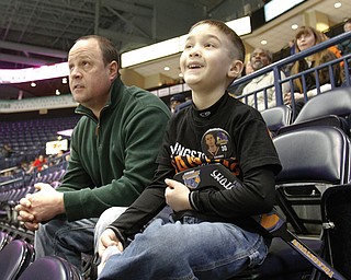 Chris Litton of Youngstown and his son Jack, 6, were among the few hardy souls who braved the brutal weather to watch the Youngstown Phantoms take on the Indiana Ice at the Covelli Centre in downtown Youngstown at the local hockey team’s annual School Day Game. The weather caused many schools to cancel classes, and few students were able to make it to the center for the 10:15 a.m. contest Wednesday. The Phantoms have set another School Day Game for March 21, when the home team will skate against Team USA.
