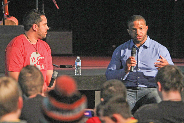 Former Warren Harding and Ohio State football standout Maurice Clarett, right, addresses the audience during a speaking engagement Wednesday at The Riot youth center of Victory Assembly of God in Coitsville. Over 150 youths from northeastern Ohio and western Pennsylvania attended the event, which was sponsored by Victory Revolution Youth Ministry, which is headed by Pastor Nate Ortiz, left, a friend of Clarett.