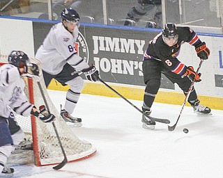 The Youngstown Phantoms’ Josh Melnick moves the puck from behind the net against Indiana Ice defender
Joshua Jacobs during the annual “School Day Game” Wednesday at the Covelli Centre in Younstown. The
Phantoms fell 7-4. It was the sixth time the two teams have faced one another and the fifth win for the Ice,
who are in first place in Eastern Conference standings.