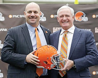 The Cleveland Browns new head coach Mike Pettine, left, poses with owner Jimmy Haslam after being introduced to the media Thursday in Berea. The former Buffalo defensive coordinator met with team officials three times in the last week before finalizing a contract Thursday. He is the Browns’ seventh full-time coach since 1999.