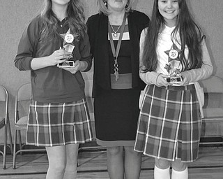 SPECIAL TO THE VINDICATOR
Holy Family School of Poland, a Lumen Christi Catholic School, recently featured its spelling bee in the school gymnasium. From the left are eighth-grader Meredith Lea, first runner-up; Kathleen Stoops, principal; and sixth-grader Audra Pesko, spelling bee champion. Audra had to correctly spell “controversy” and then “environment.” Audra will represent Holy Family at the Vindicator Spelling Bee on March 15 at Youngstown State University.