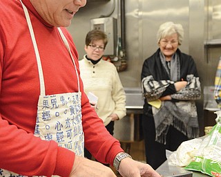 Dr. Y.T. Chiu uses a cleaver to chop up a roasted duck while Wendy Owens, left, and Beverly Italiano watch.
He and his wife, Marilyn, presented “From the Garden: Chinese New Year” at Fellows Riverside Gardens.