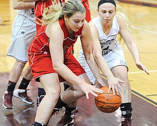 Fitch’s Cassie Custer, left, and Boardman’s Jenna Kuczek wrestle for a loose ball during Monday’s game at Boardman High. The Spartans won, 52-49.