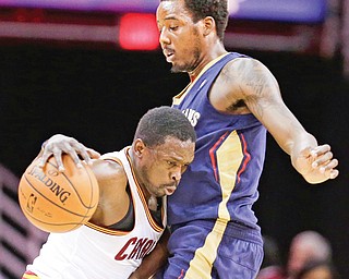 The Cavaliers’ Luol Deng, left, drives around the Pelicans’ Al-Farouq Aminu during the first quarter of their
NBA game, Tuesday at Quicken Loans Arena in Cleveland. Cleveland fell to New Orleans, 100-89. Deng, who
has been slowed by an injured Achillies, scored only six points.