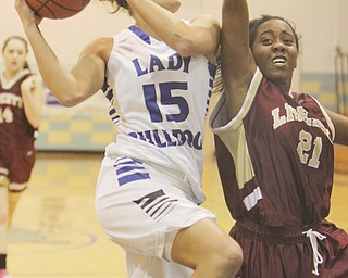 Lakeview senior Alli Pavlik (15) goes in for a layup while being defended by Liberty’s Sabrina Francis (21) during the first quarter of their game Thursday at Lakeview High School in Cortland. The Bulldogs downed the Leopards, 86-43, to remain undefeated. Pavlik had a game-high 25 points and had 12 steals, which broke the record of 11 set by Sandy Stocz in 1989.