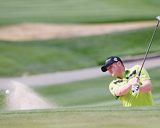 Warren JFK graduate Jason Kokrak hits out of the sand on the ninth hole during Round 1 of the Phoenix
Open on Thursday in Scottsdale, Ariz. Kokrak shot a 66 for the day to finish two shots off the the lead at 5-under.