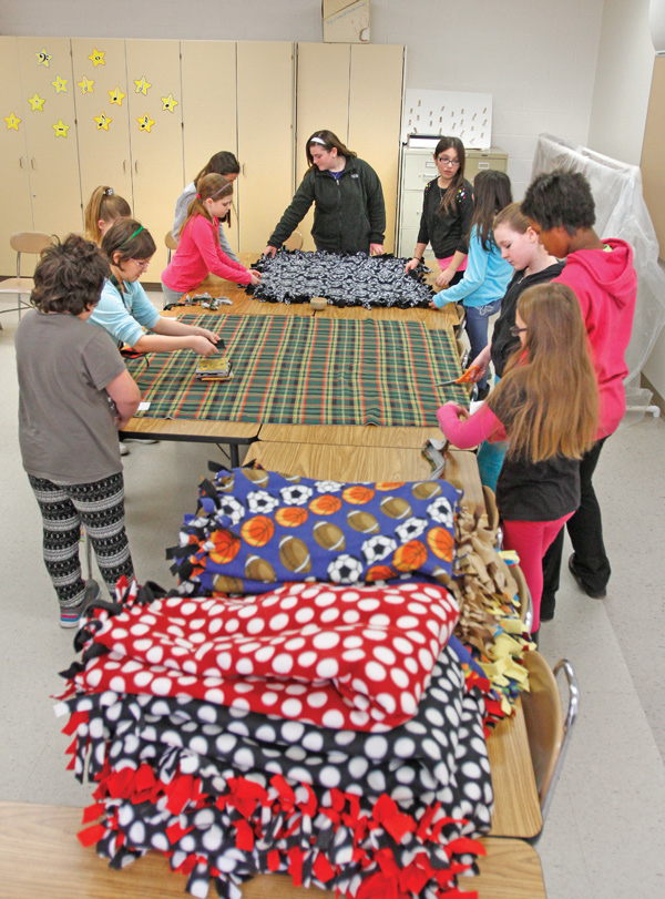 Fourth-, fifth- and sixth-grade students at Girard Intermediate School make tie-blankets. The girls donate the blankets, most recently to the Rescue Mission during the cold snap.