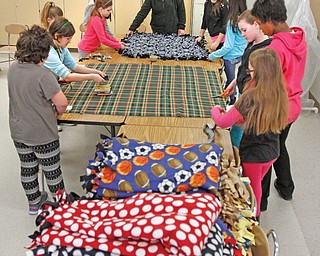 Fourth-, fifth- and sixth-grade students at Girard Intermediate School make tie-blankets. The girls donate the blankets, most recently to the Rescue Mission during the cold snap.