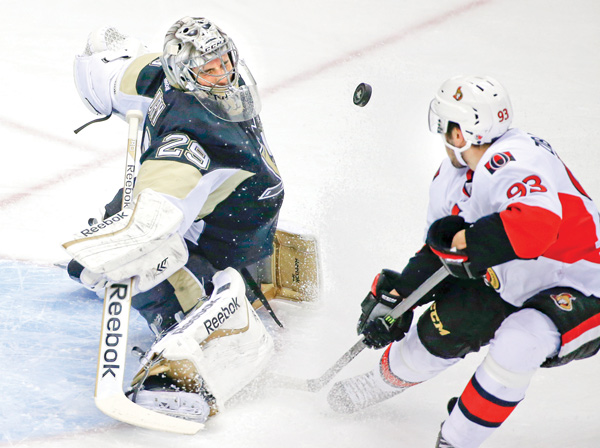 Pittsburgh Penguins goalie Marc-Andre Fleury (29) makes a save on a shot by Ottawa Senators’ Mika Zibanejad
(93) in the first period of a game in Pittsburgh.