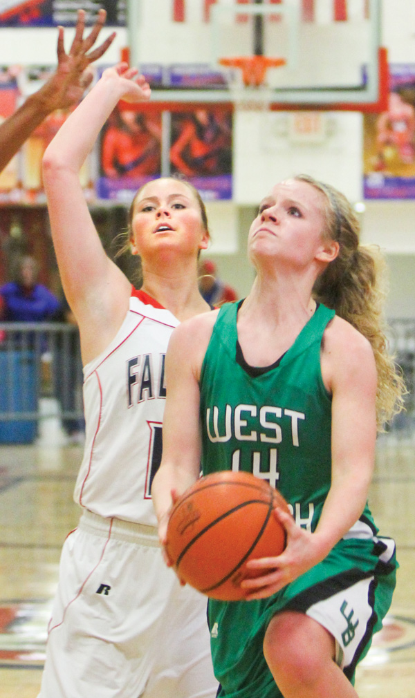 West Branch’s Melinda Trimmer (14) scored her 1,000th point during Monday’s game in Austintown. Guarding
her is Fitch’s Sarah Melfe.