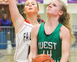 West Branch’s Melinda Trimmer (14) scored her 1,000th point during Monday’s game in Austintown. Guarding
her is Fitch’s Sarah Melfe.