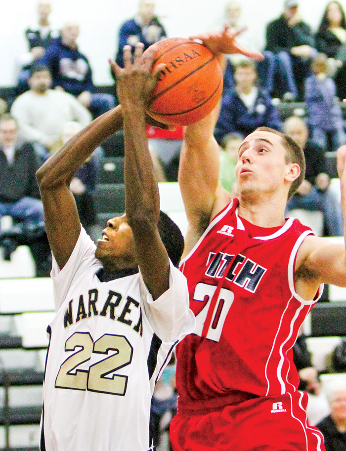 Fitch’s Alex DiFrancesco(20) defends Warren Harding’s King Garner (22) during Tuesday’s game in Warren. Harding defeated Fitch 71-44.

