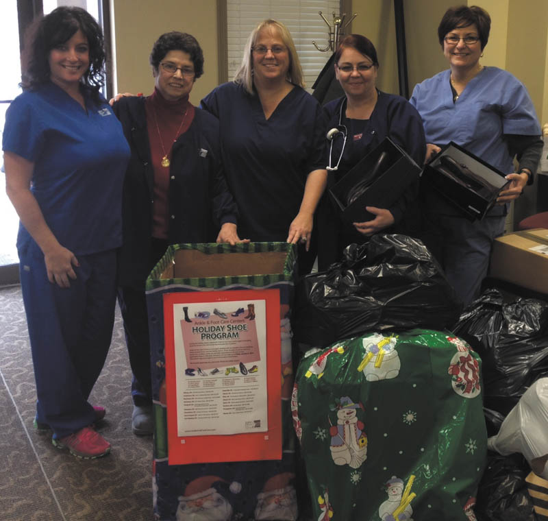 SPECIAL TO THE VINDICATOR
Employees of Ankle & Foot Care Centers, from left, Lisa Troutman, Betty Emch, Stacy Doyle, Lynn Wyatt and Denise Cutrone, show some of the bags of shoes donated through the practice’s annual shoe drive. More than 700 pairs of shoes will be distributed to local families this month thanks to their efforts. Ankle & Foot Care provided the shoes recently to the Salvation Army for distribution to families in Mahoning and Trumbull counties. The new and nearly new shoes were donated by patients, employees and podiatrists from late November to mid-January.