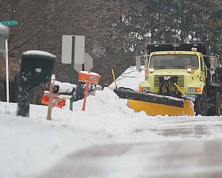 A Boardman road department truck plows snow from Spring Garden Drive on Wednesday afternoon after Mother Nature dumped another several inches of snow on the Mahoning Valley on Tuesday night into Wednesday. Many road departments across the Valley are dealing with dwindling road salt supplies because of the long winter.