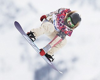 Jamie Anderson of the United States takes a jump on her first run in the women’s snowboard slopestyle final Sunday at the 2014 Winter Olympics in Krasnaya Polyana, Russia.
