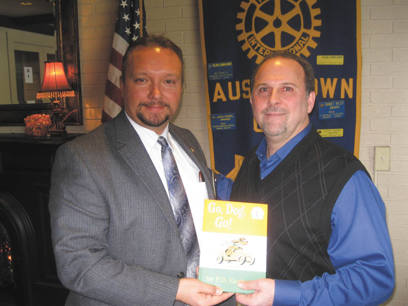 SPECIAL TO THE VINDICATOR
David Ditzler, right, Mahoning County Commissioner, was the guest speaker at the Jan. 27 meeting of Austintown Rotary Club. Mark Cole, left, Rotary president, presented him with a book for the Austintown Elementary School library. Ditzler spoke about how county funds are raised and allocated. He pointed out that 61 of Ohio’s 88 counties have taxes higher than Mahoning County.