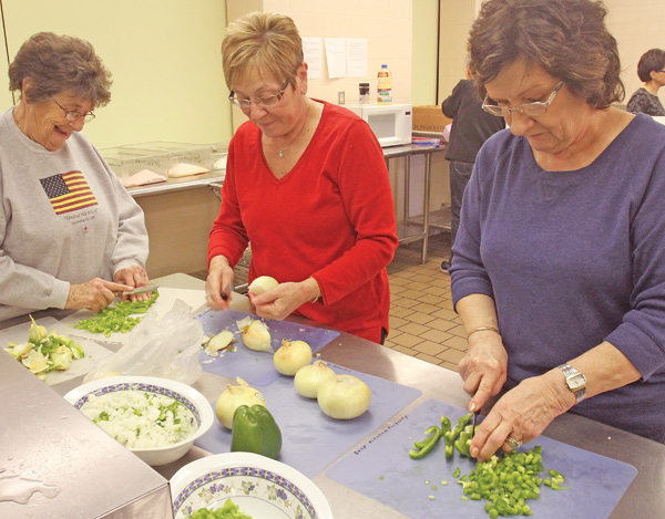 Members of St. Charles Borromeo Church in Boardman volunteer with the second Monday of the month kitchen crew. From left are Barbara Oliver, Mary Grace Fowler and Roe Palazzo. The food they make is served at St. Vincent de Paul dining hall in Youngstown.