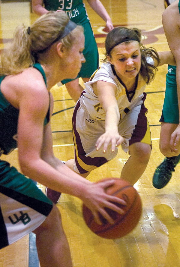 South Range sophomore Morgan Czopur lunges for the ball held by West Branch’s Melinda Trimmer during Monday’s game in Beaver Township. The Warriors won, 61-38.